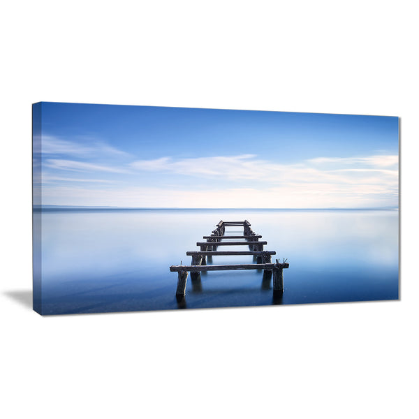 jetty remains in blue lake seascape photo canvas print PT8366